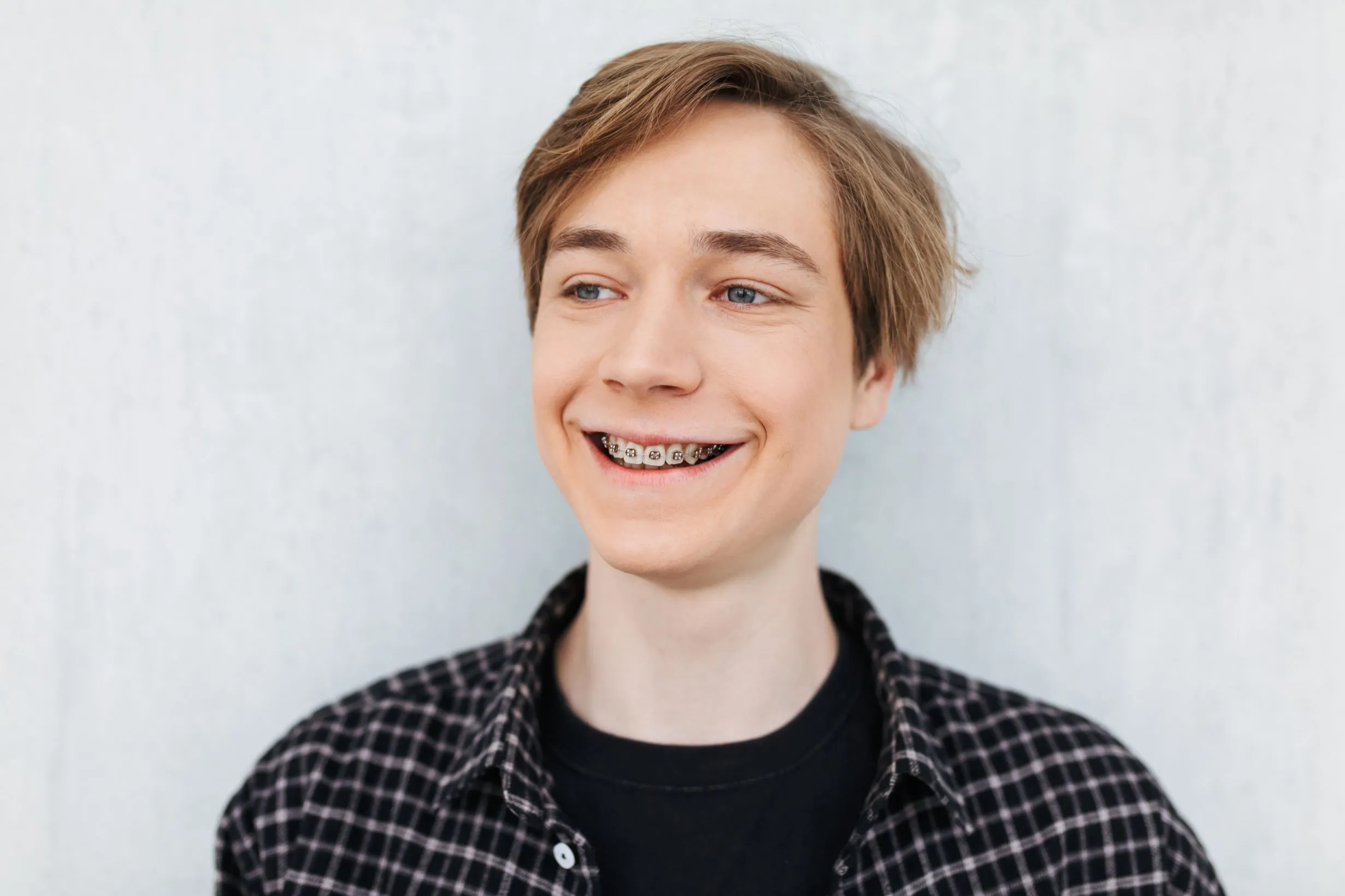 Smiling young man with braces