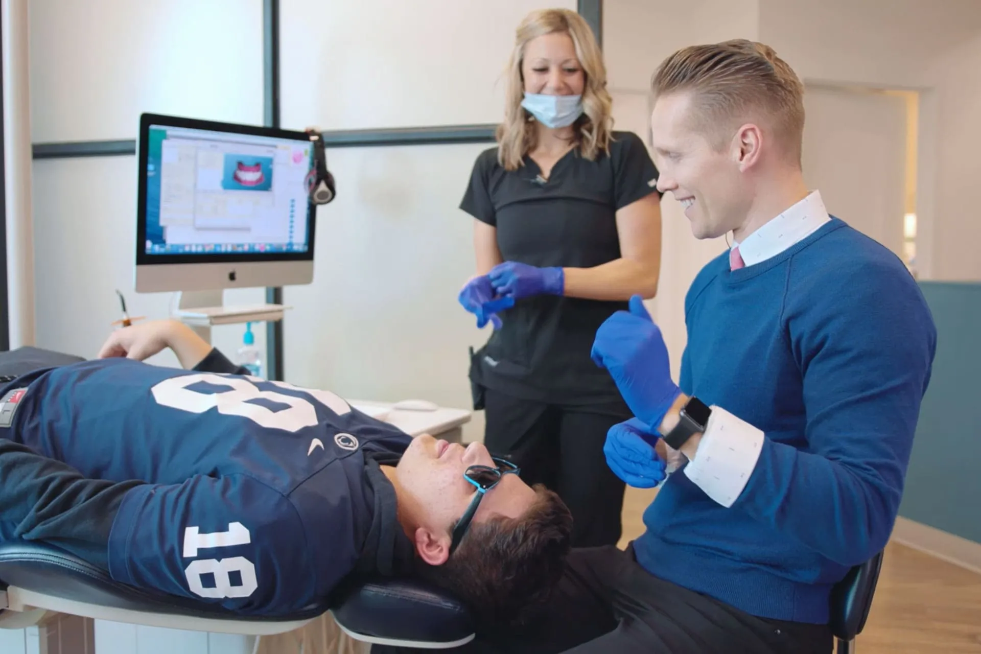 Orthodontist and team member treating a person in the chair